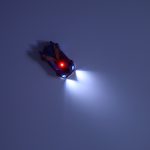 RC laser-controlled car driving on a wall on laser blue